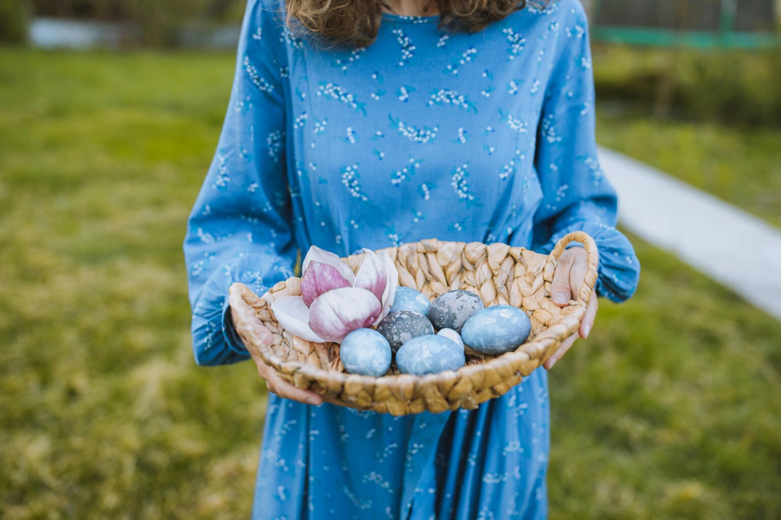 a girl wearing an Easter dress while holding an Easter basket
